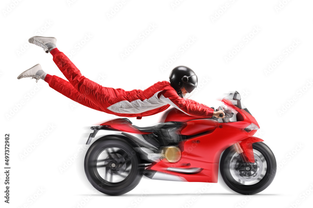 Racer flying and holding onto a red motorbike