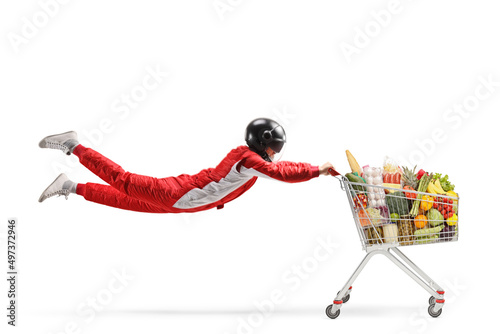 Car racer flying and holding a shopping cart with food © Ljupco Smokovski