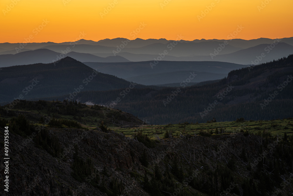 sunrise overlooking layers of mountains