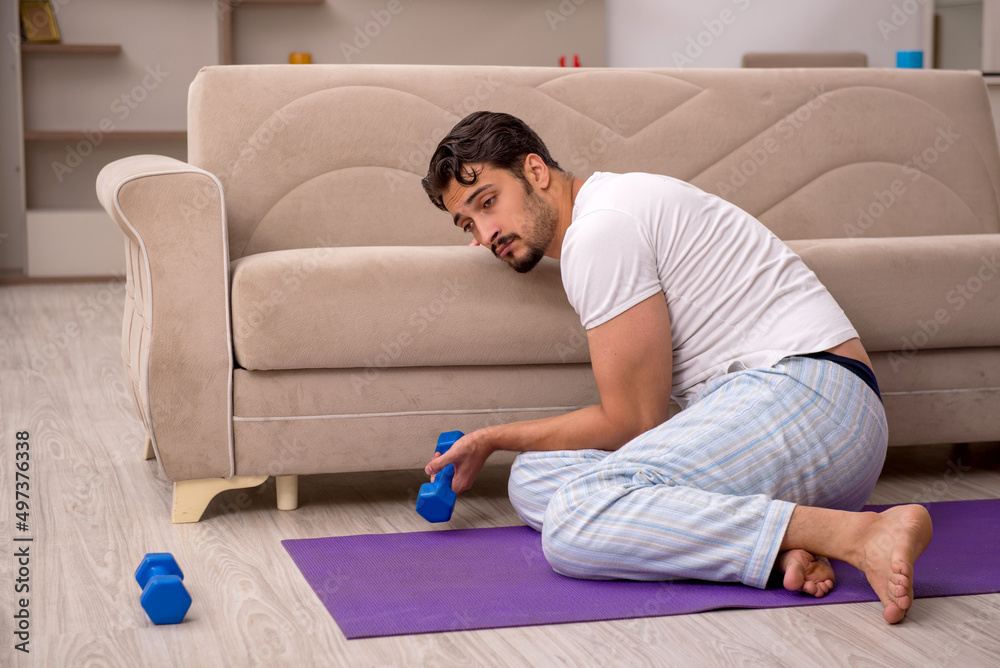 Young man doing sport exercises at home Young man doing sport exercises at home