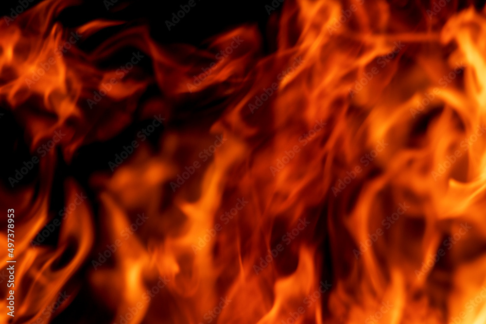 Abstract flame, fire flame texture, background. Blurred moving tongues of fire on a dark background.