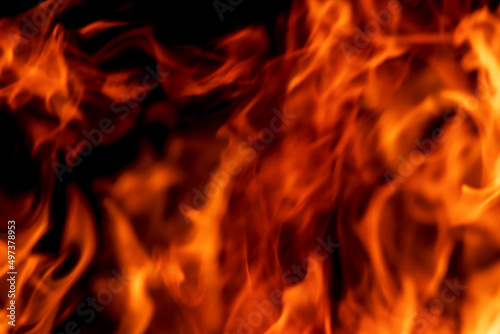 Abstract flame, fire flame texture, background. Blurred moving tongues of fire on a dark background.