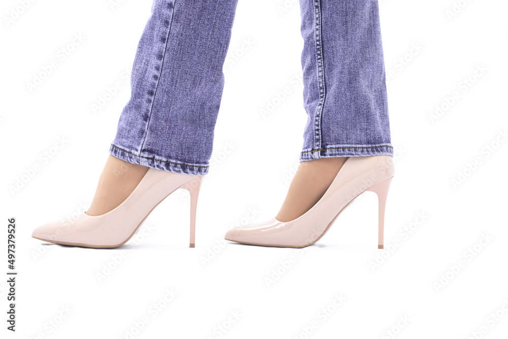 Slender female legs in high-heeled patent leather shoes. Skinny purple jeans. Fashion and Style. side view