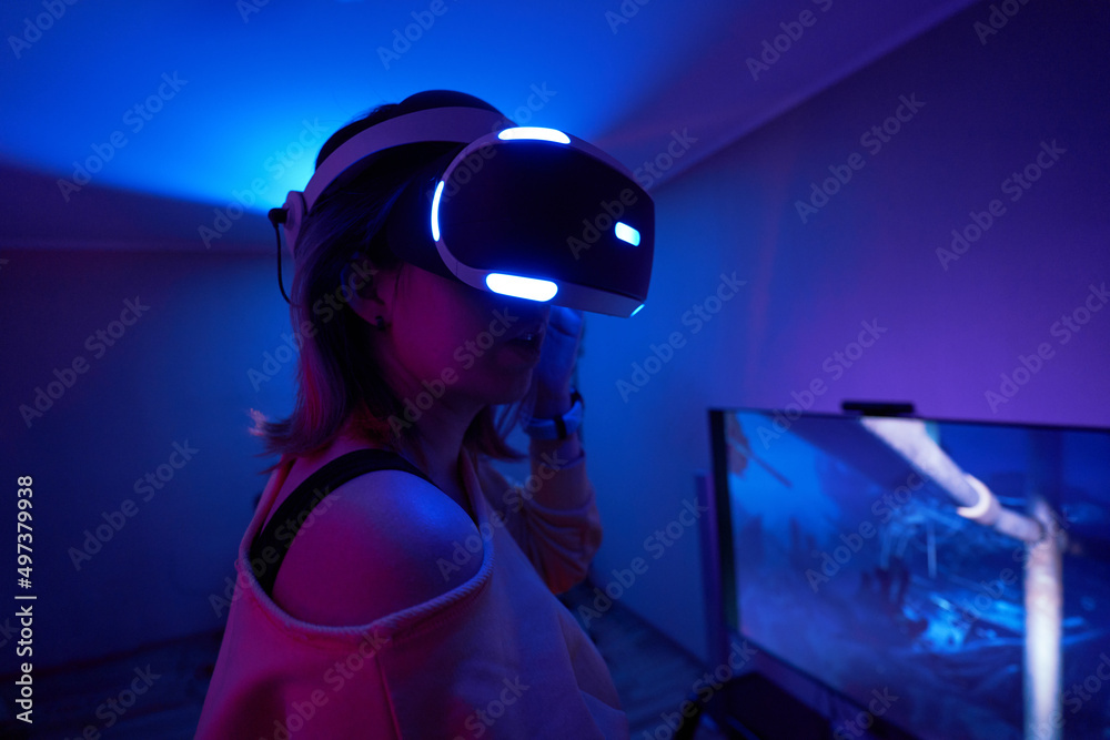 Woman interacts with virtual reality using a vr headset. Woman interacts with virtual reality using a vr headset.