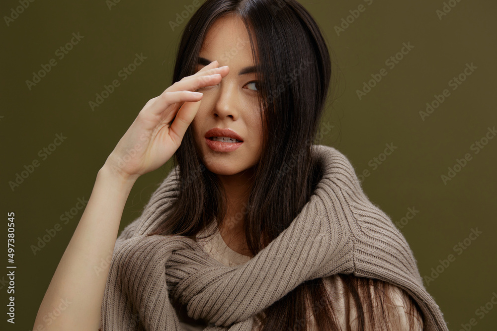 woman sweater on the shoulders posing clothing fashion Green background woman sweater on the shoulders posing clothing fashion Green background
