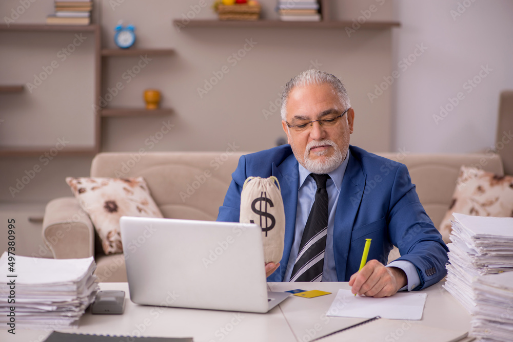 Old male boss working from home in remuneration concept Old male boss working from home in remuneration concept