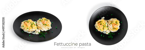 Fettuccine pasta with shrimp in cream sauce on white plate isolated on a white background. Nests of pasta with seafood and cheese.