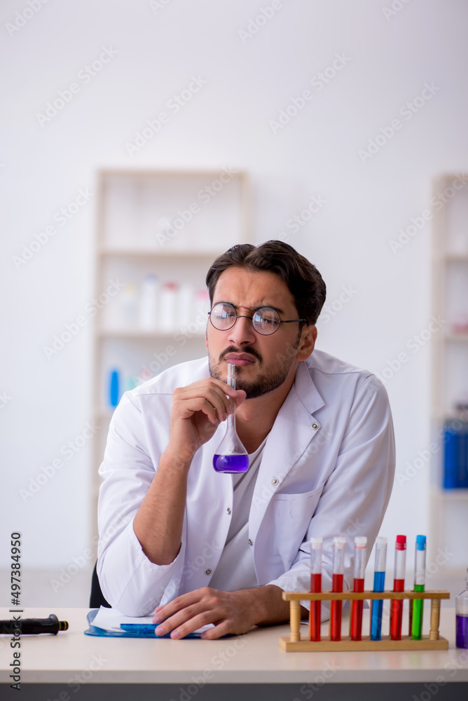 Young male chemist working at the lab Young male chemist working at the lab
