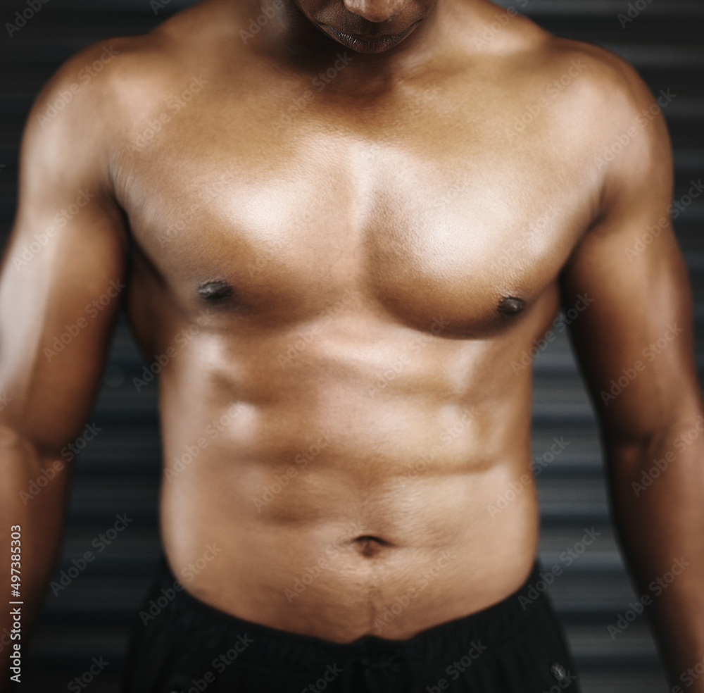 Hes all muscle. Cropped shot of a shirtless man with defined abs. Hes all muscle. Cropped shot of a shirtless man with defined abs.