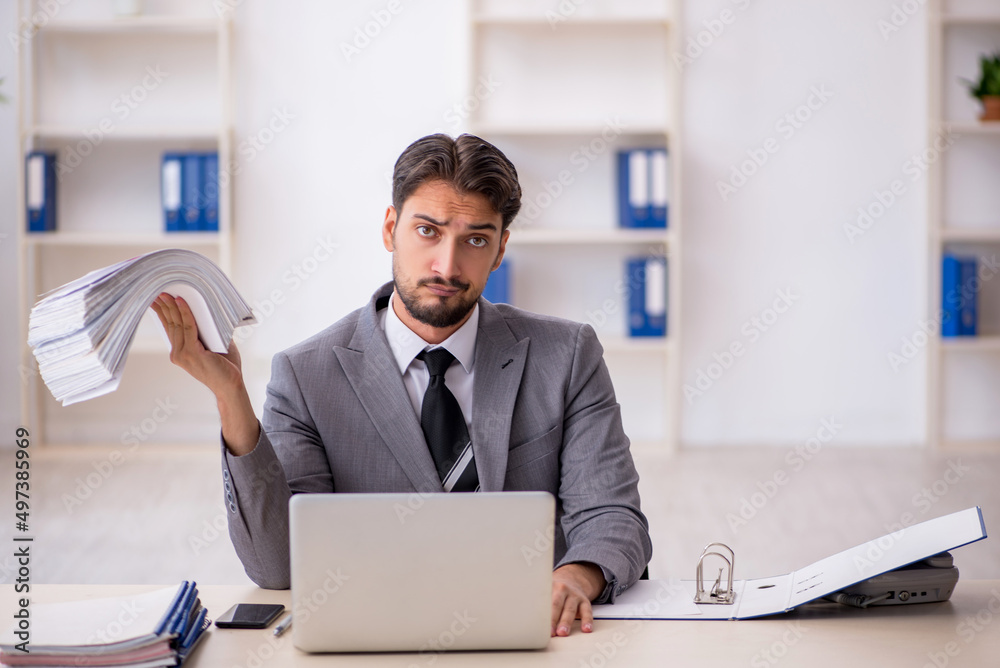 Young male employee working in the office Young male employee working in the office