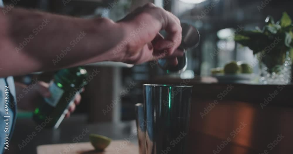 Bartender pouring alchol in a shaker Bartender pouring alchol in a shaker