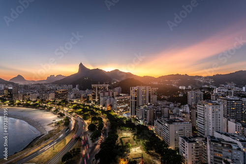 Beautiful view on blue hour to city beach, buildings and mountains photo