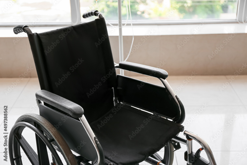Modern wheelchair in empty room Modern wheelchair in empty room