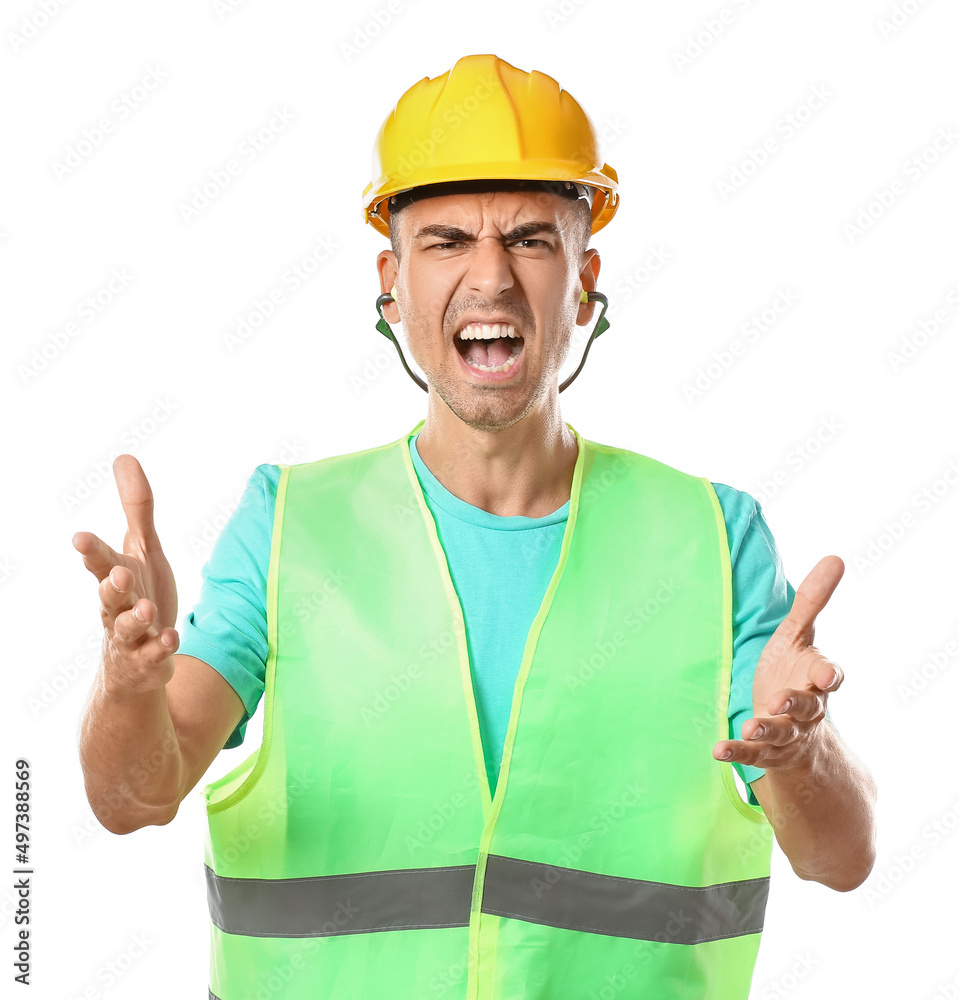 Angry male builder with earplugs on white background
