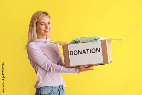 Young woman holding box wit...