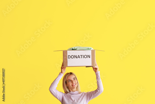 Young woman holding box wit...