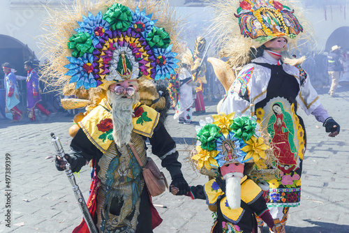 A participant in Carnival in Huejotzingo wearing traditional dress dancing.
