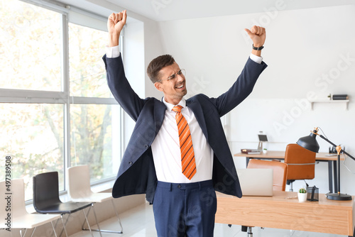 Dancing young businessman i...