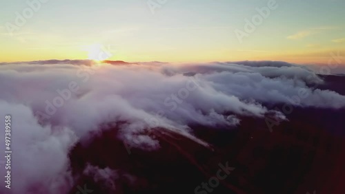 4K Drone flies in the clouds. Flight through the clouds during sunrise, top view of the clouds from the drone. National Park Shipit Karpat. Carpathians, Pylypets, Ukraine.  photo