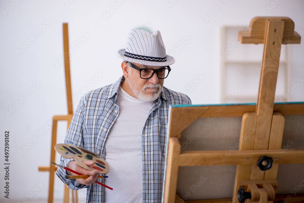 Old man enjoying painting at home Old man enjoying painting at home
