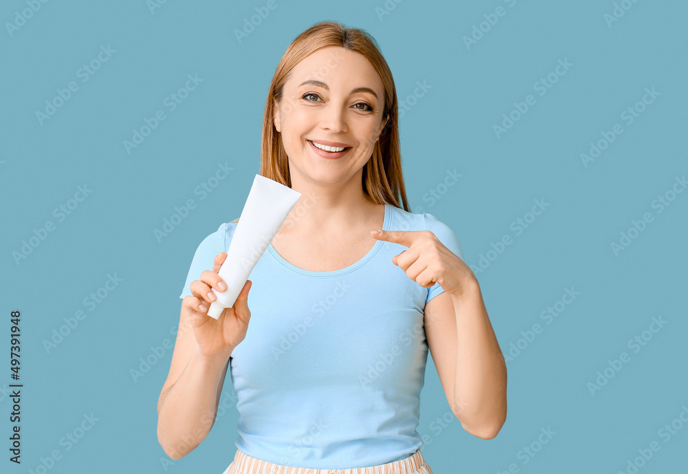 Beautiful mature woman with tooth paste on blue background Beautiful mature woman with tooth paste on blue background