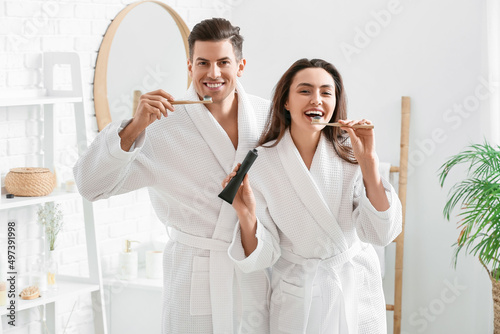 Young couple brushing teeth...