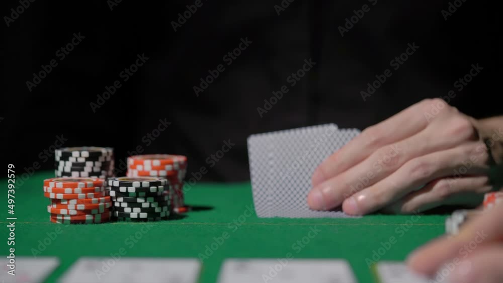 Gamer person playing poker in casino. Betting chips stacks. Dealer and gambler. Gamer person playing poker in casino. Betting chips stacks. Dealer and gambler.