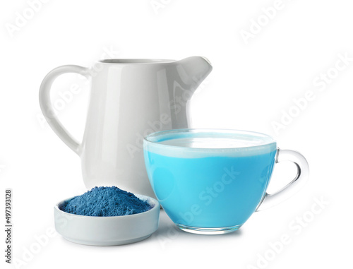 Jug, cup of blue matcha tea and powder isolated on white
