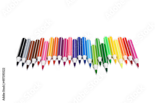 A set of bright multi-colored markers on a white isolated background. Colorful children's felt-tip pens folded in a row at different lengths. Close-up shot, front view.