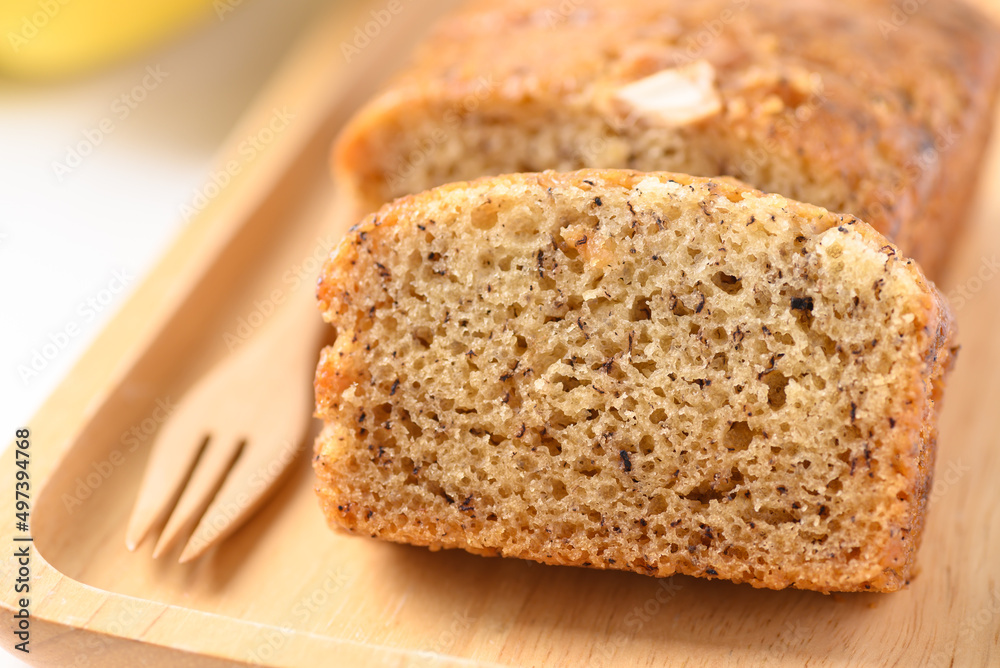 Banana bread on wooden plate with fork ready to eating