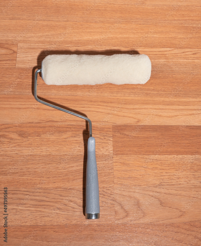 manual hand held metal paint roller with fresh new roll being changed