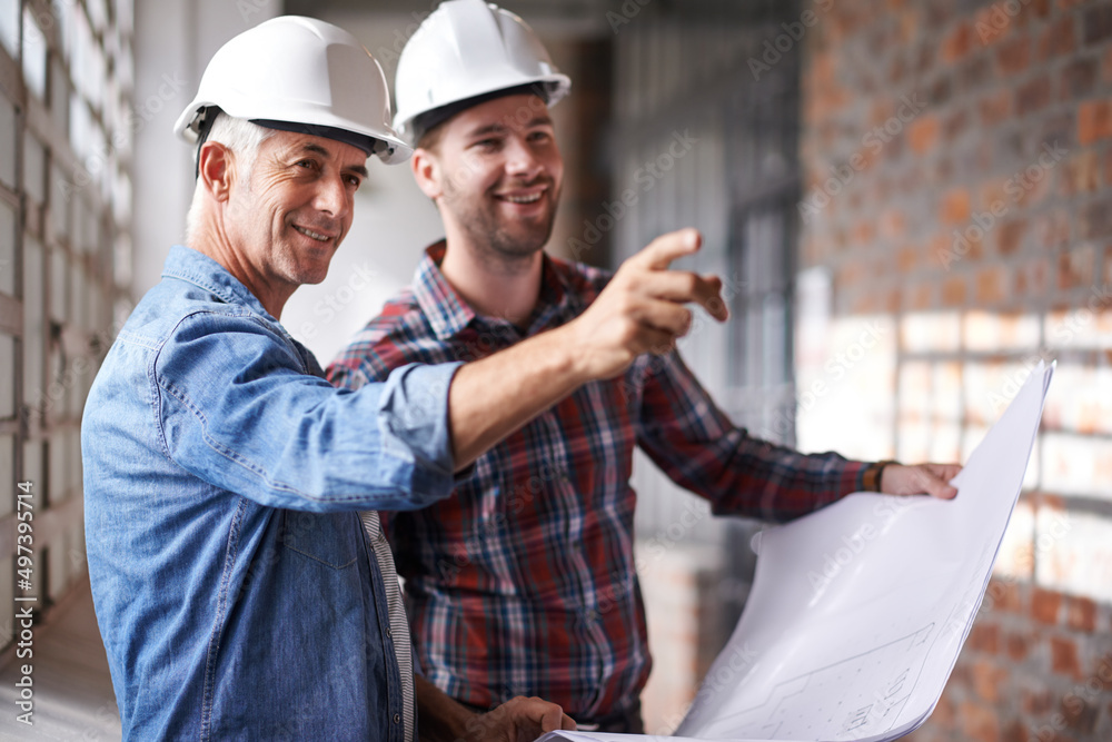 Lets start over there. Shot of two male architects wearing hardhats inspecting a building. Lets start over there. Shot of two male architects wearing hardhats inspecting a building.