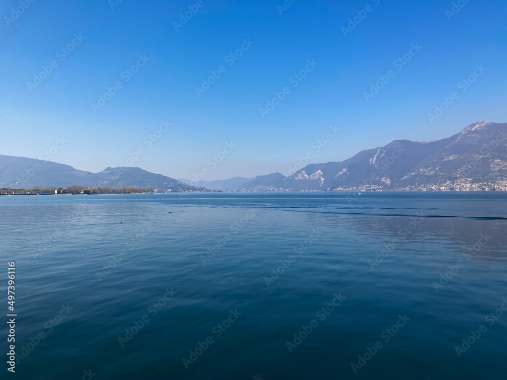 Bergamo, Italy: 10-02-2022: Panoramic of Lake Iseo, the fourth largest lake in Lombardy, Italy, fed by the Oglio River.