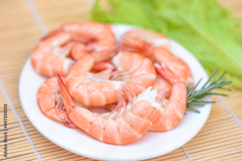 Fresh shrimps served on white plate, boiled peeled shrimp prawns cooked in the seafood restaurant Fresh shrimps served on white plate, boiled peeled shrimp prawns cooked in the seafood restaurant