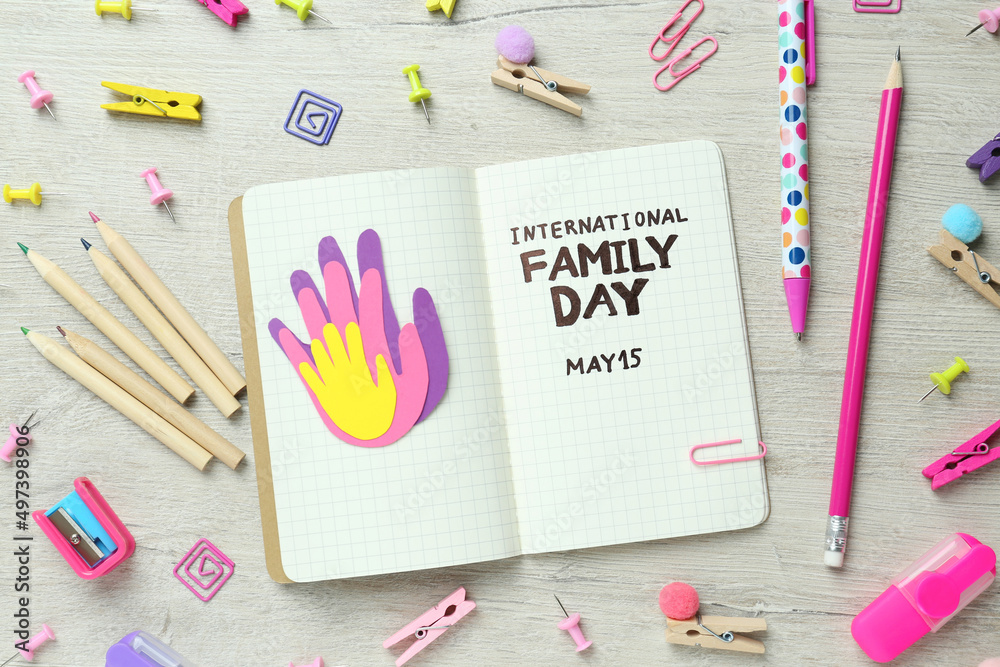 Happy Family Day. Flat lay composition with notebook and stationery on wooden table Happy Family Day. Flat lay composition with notebook and stationery on wooden table