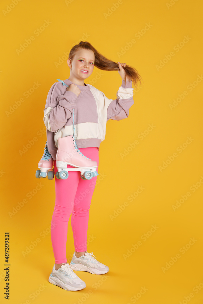 Cute indie girl with roller skates on yellow background Cute indie girl with roller skates on yellow background