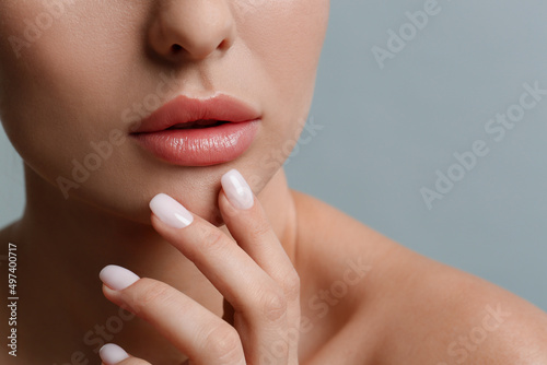 Woman with beautiful lips on light grey background  closeup