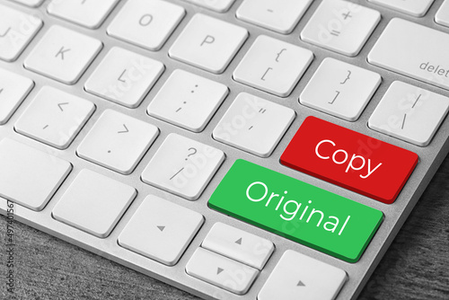 Color buttons with words Copy and Original on keyboard, closeup view. Plagiarism concept