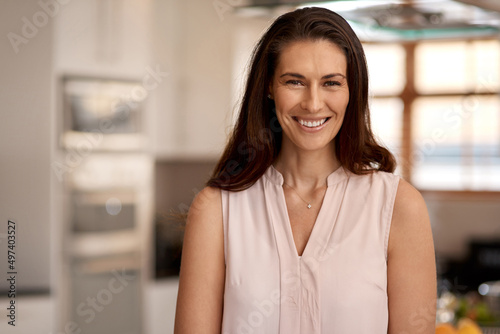 Free Download That smile says it all. Cropped portrait of an attractive young woman standing in the kitchen at home. - GFXLoad
