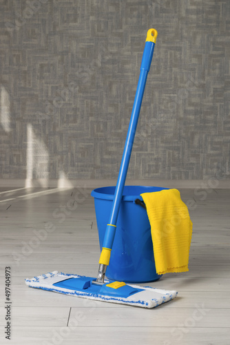 A mop, a bucket and a rag in the cleaning room. The concept of maintaining cleanliness. Flat lay.