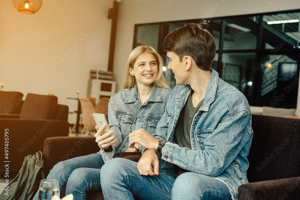 Young traveler lover couple siting on terminal chair seat with luggage suitcase, laughing and having fun times together. Young traveler lover couple siting on terminal chair seat with luggage suitcase, laughing and having fun times together.