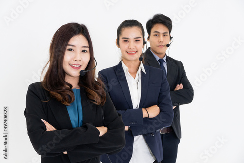 Group of Asian call center or IT support with headphone in arms crossed standing on white background. Corporate business team for teamwork concept. Customer after service.