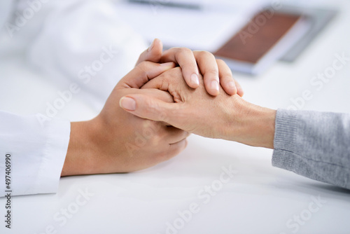Things will get better with time. Closeup shot of a doctor holding a patients hand in comfort.