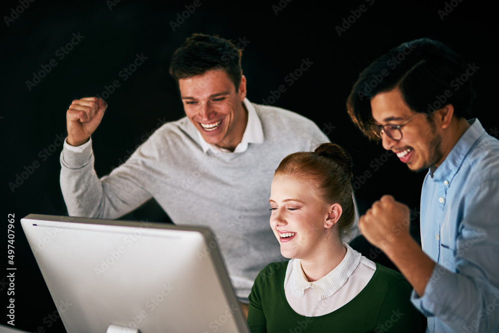 Day or night, we win all the time. Shot of a group of businesspeople cheering while working together in an office at night. Day or night, we win all the time. Shot of a group of businesspeople cheering while working together in an office at night.