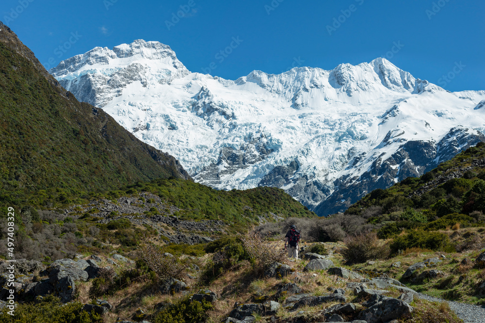 Hiking Kea Point track at Mt Cook National Park, Mt Sefton and the Footstool mountains towering above the track, New Zealand.