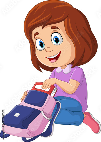 Cute little girl putting a book in her bag