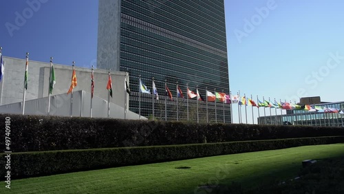 Flags in front of United Nations in NYC. International community. Flags flying in the wind in slow motion photo