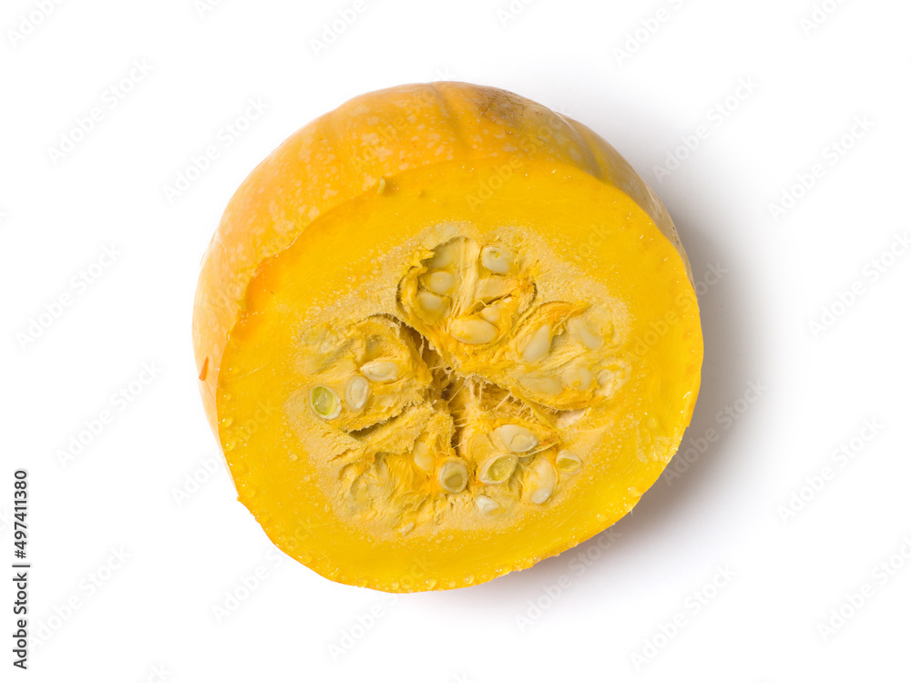 Cut yellow pumpkin on a white background. Studio photography. View from above