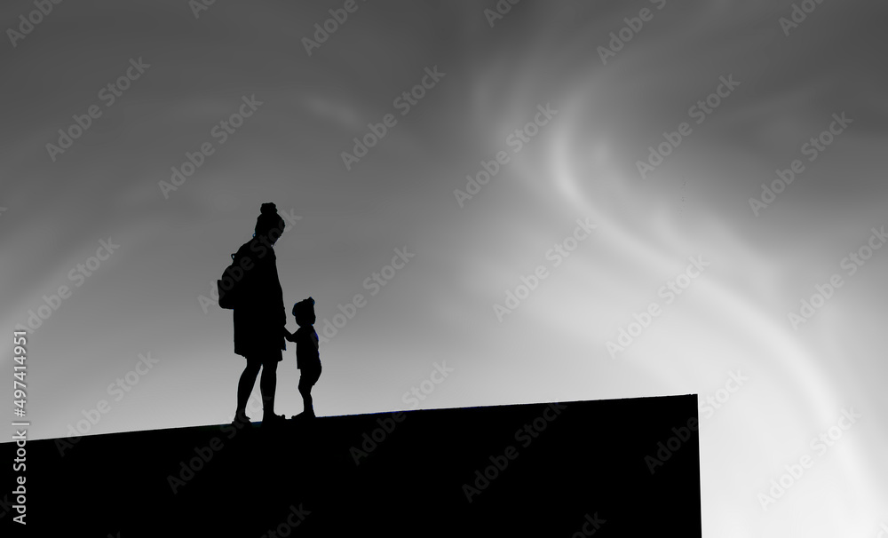 woman with child silhouette with clouds