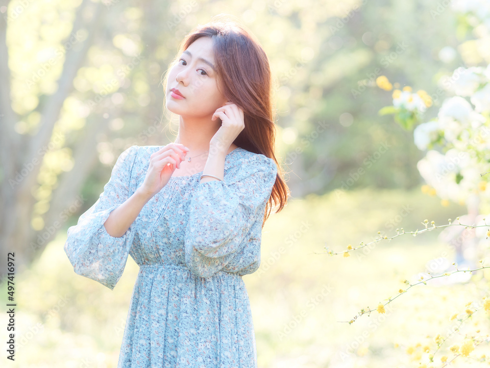 Portrait of elegant Chinese girl in dress enjoy carefree time in forest park in sunny day. Outdoor fashion portrait of glamour young Chinese cheerful stylish woman. Portrait of elegant Chinese girl in dress enjoy carefree time in forest park in sunny day. Outdoor fashion portrait of glamour young Chinese cheerful stylish woman.